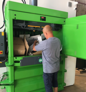 baler being loaded with cardboard